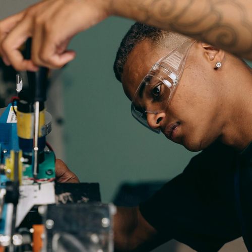Man in engineering attire with technical equipment behind