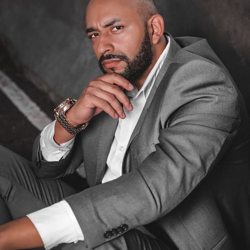 Man in formal business attire with confident expression