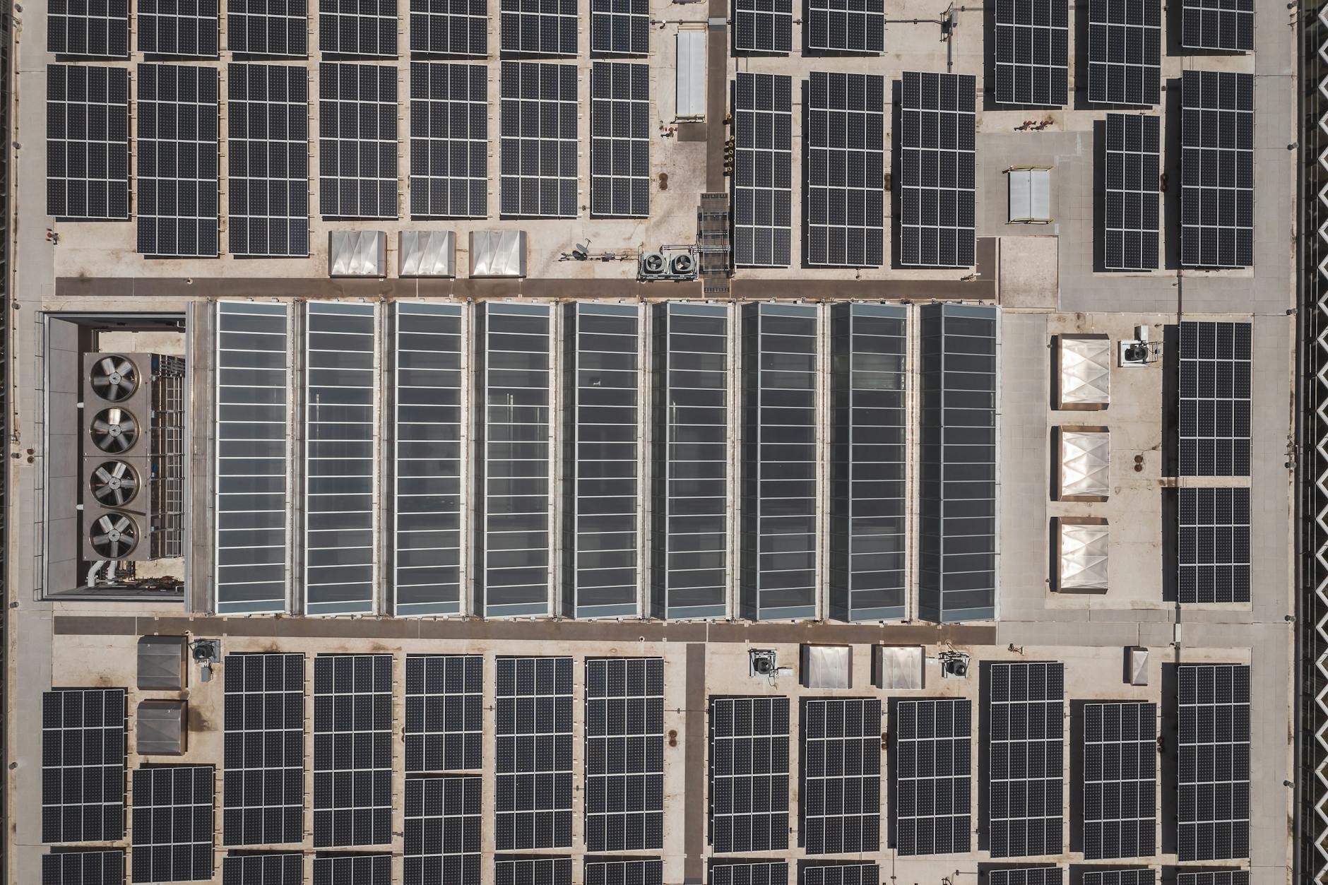 Solar panel array on industrial building rooftop